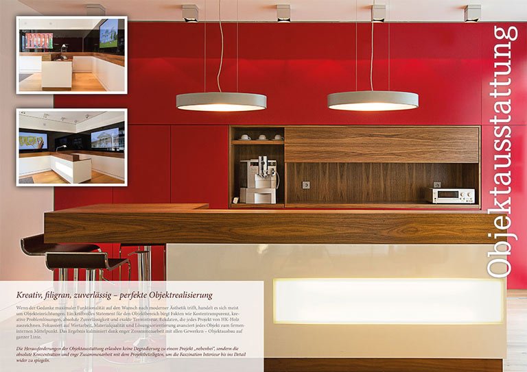 Innenraumfotografie einer modernen K&uuml;che mit roten W&auml;nden und stilvollen Pendelleuchten.